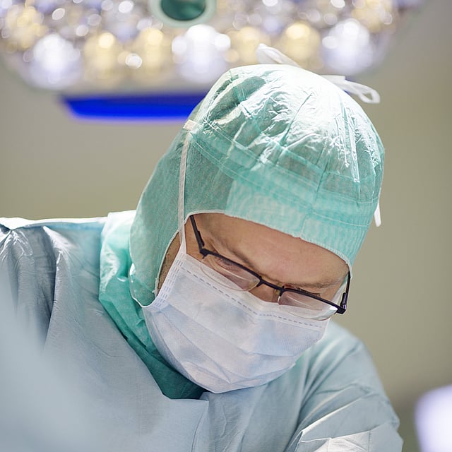 Ein Arzt, der eine Maske und eine Gesichtsmaske trägt.